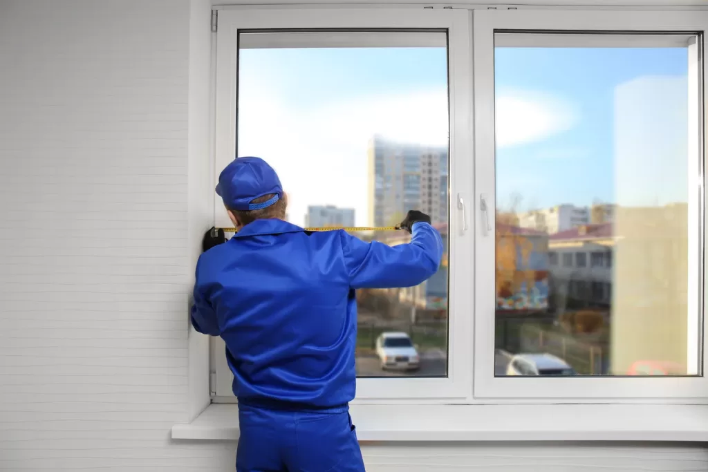 Residential Glass Repair Technician Measuring window for glass replacement in Richmond