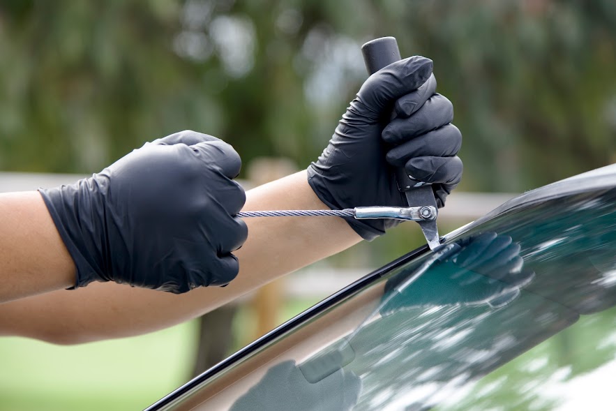 Man repairing and replacing the glass on a car. Avada Car Dealer News